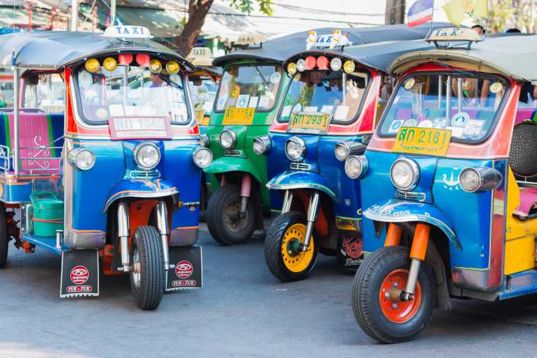 01 03 770 Bangkok Editorial Thai Tuk Tuk taxi on Maharaj Road Rattanakosin Island of Bangkok shutterstock 390665227